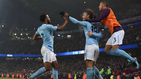 Manchester City's English midfielder Raheem Sterling (L) celebrates after scoring their third goal with Manchester City's German midfielder Leroy Sane during the English Premier League football match between Manchester City and Tottenham Hotspur at the Etihad Stadium in Manchester, north west England, on December 16, 2017. / AFP PHOTO / PAUL ELLIS / RESTRICTED TO EDITORIAL USE. No use with unauthorized audio, video, data, fixture lists, club/league logos or 'live' services. Online in-match use limited to 75 images, no video emulation. No use in betting, games or single club/league/player publications.  / 